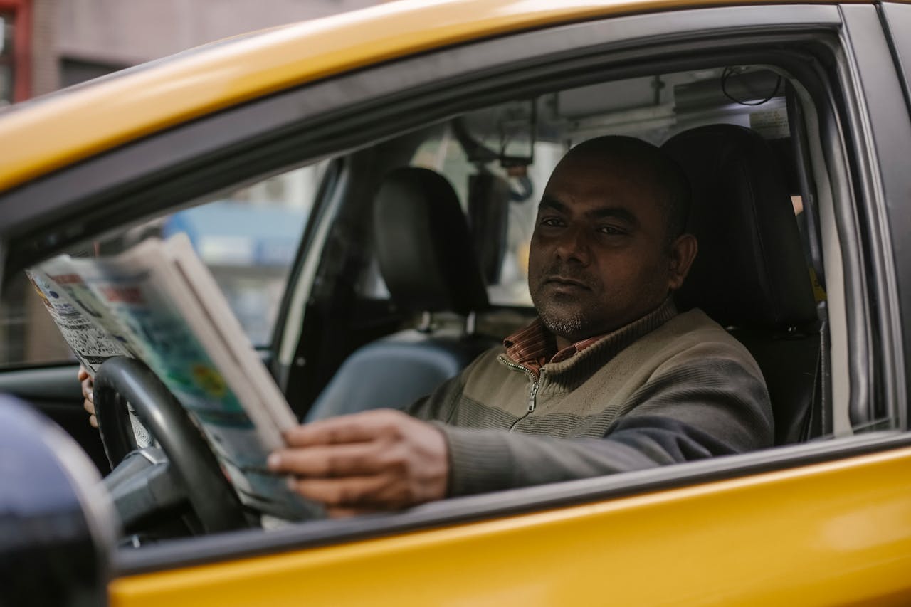 Photo by Tim  Samuel: https://www.pexels.com/photo/serious-ethnic-male-taxi-driver-reading-newspaper-5835354/